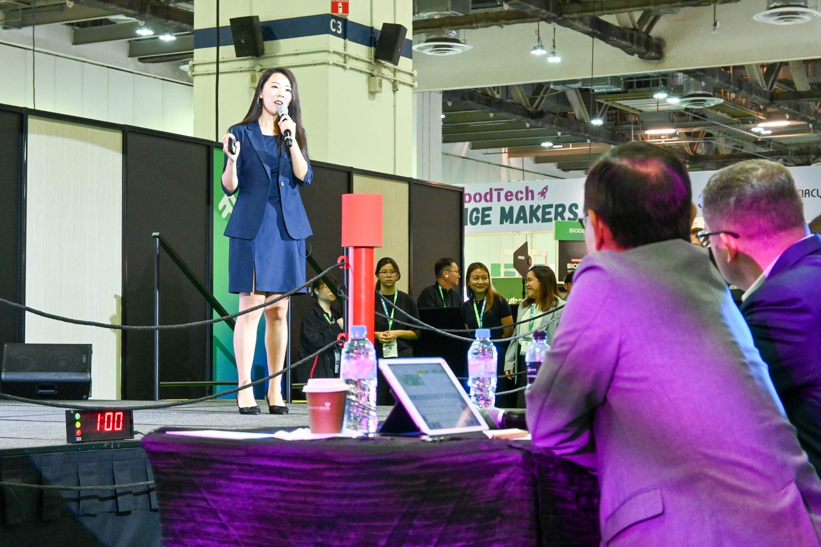Emily Chih pitching on stage in Singapore